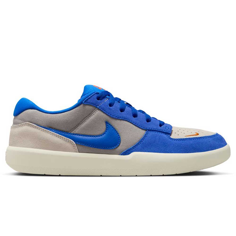 The DV5477-011 College Grey Racer Blue Light Orewood Nike SB Force 58 features blue suede overlays, a bright blue Swoosh, grey and beige panels, blue laces, white cupsole, and an orange toe detail for classic skate style with basketball heritage.