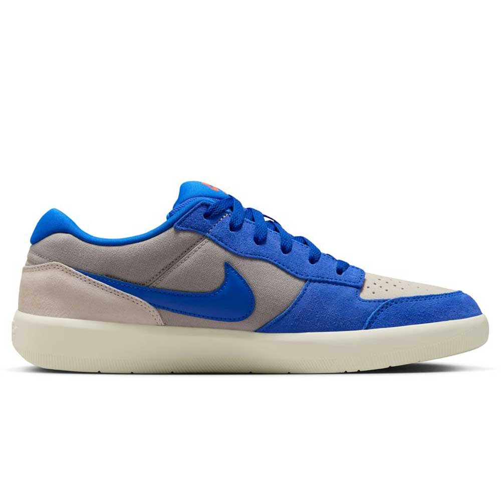 Side view of the Nike SB Force 58 DV5477-011, featuring a College Grey suede upper with Racer Blue accents, blue laces, a beige cupsole, and a blue Swoosh. This modern skate shoe fuses heritage basketball style with skateboarding performance.