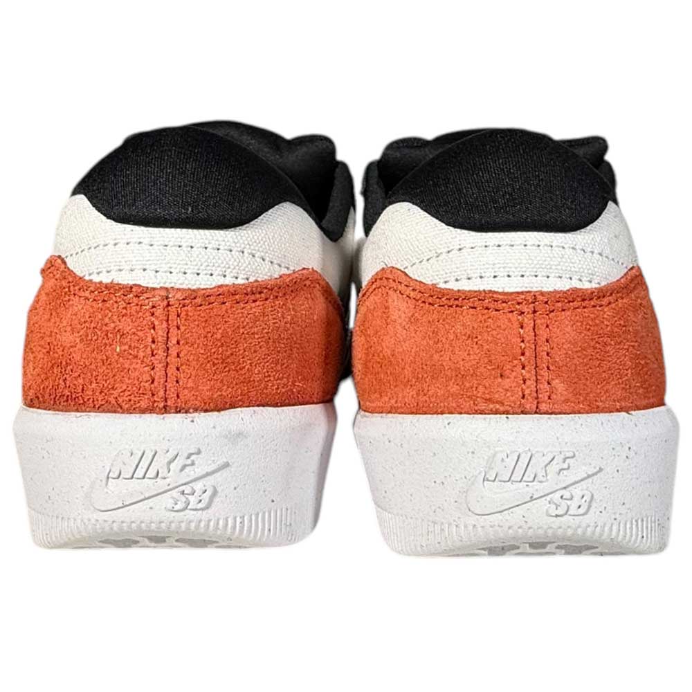A rear view of two Nike SB Force 58 Suede Skateboarding Shoes in Black Cosmic Clay and White, featuring white midsoles, burnt orange suede heel panels, black and white uppers, and embossed Nike SB logos on each heel.