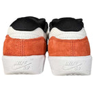 A rear view of two Nike SB Force 58 Suede Skateboarding Shoes in Black Cosmic Clay and White, featuring white midsoles, burnt orange suede heel panels, black and white uppers, and embossed Nike SB logos on each heel.