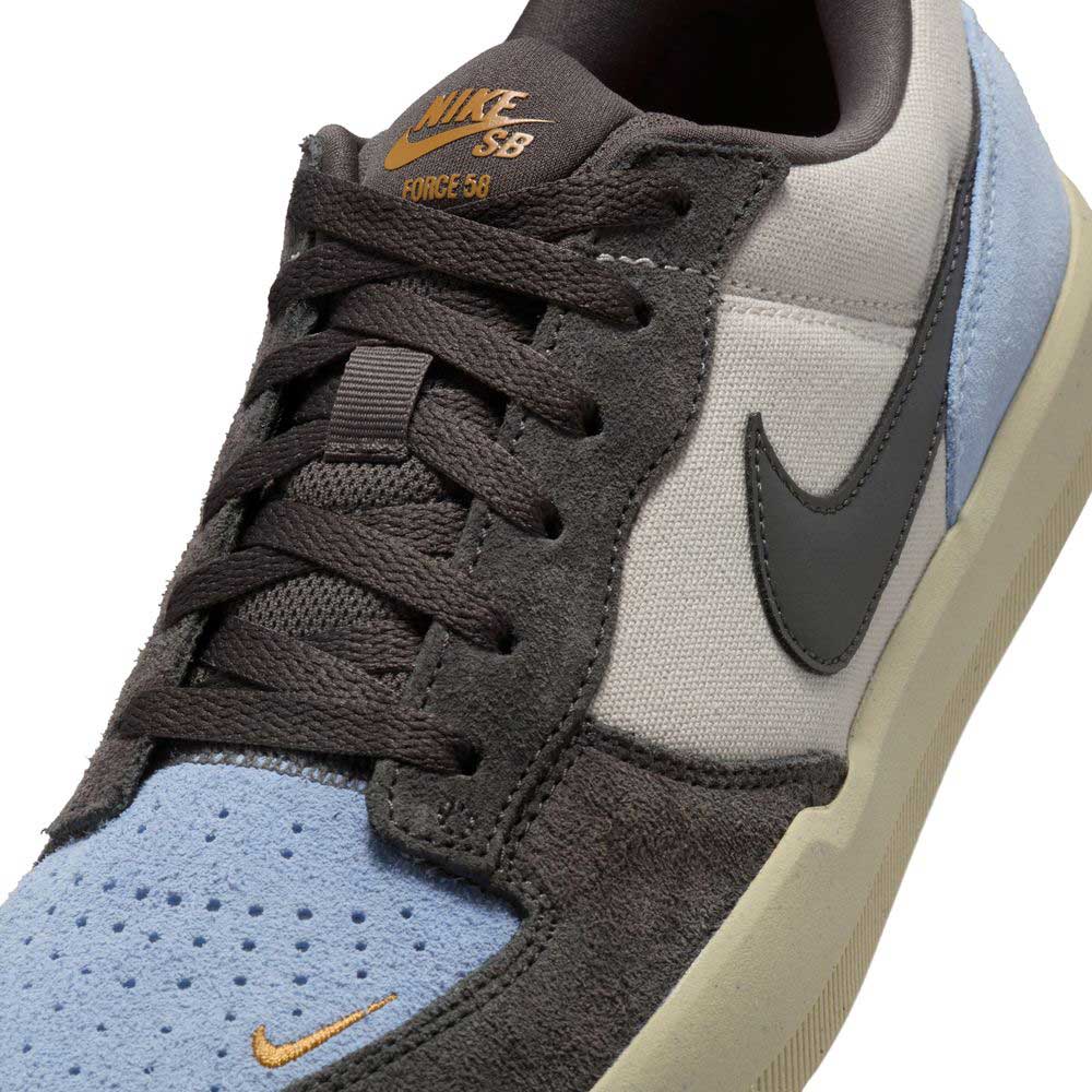 Close-up of the DV5477102 Light Orewood Brown Medium Aah Force 58 Nike SB suede skateboarding shoe, featuring multicolor panels, black laces, cupsole construction, black Nike swoosh, and orange Nike SB branding on the tongue and toe.