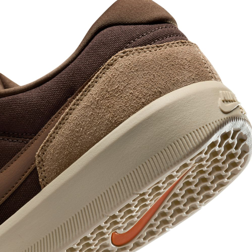 Close-up of DV5477-201 Baroque Brown Mosswood Brown Force 58 Nike SB suede skateboarding shoes, featuring textured suede and fabric upper, beige grippy sole, and orange Swoosh—combining basketball heritage with modern cupsole style.