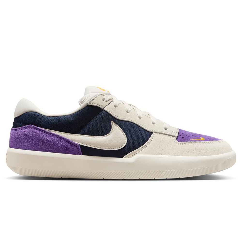 The DV5477-403 Obsidian Light Orewood Brn Force 58 Nike SB Suede Skateboarding Shoe features a beige sole and laces, navy and beige suede panels, purple accents, and a white Swoosh, blending classic basketball-inspired style with skate functionality.