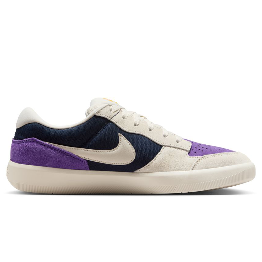 The DV5477-403 Obsidian Light Orewood Brn Force 58 Nike SB Suede Skateboarding Shoes feature a beige sole and trim, navy side panel, purple suede heel and toe, beige laces and Swoosh—blending basketball DNA with skate style. Side profile on white background.