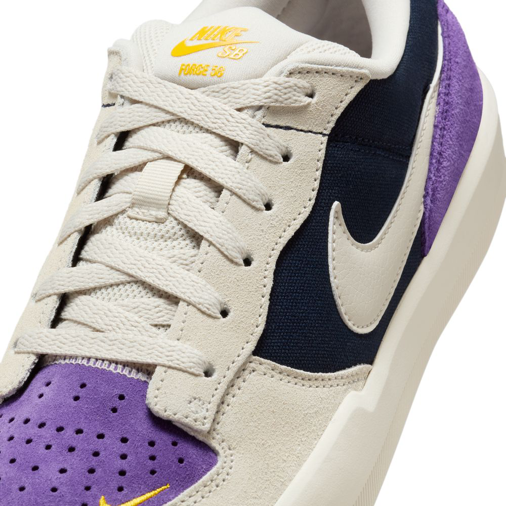 Close-up of DV5477403 Obsidian Light Orewood Brn Force 58 Nike SB suede skateboarding shoes, featuring cream laces, black and cream panels, a white swoosh, and a purple suede toe with gold Nike SB branding—blending hoops DNA with skate style.