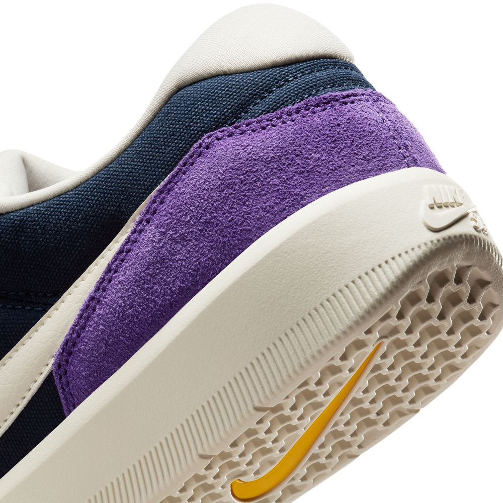 Close-up of the heel and sole of the DV5477403 Obsidian Light Orewood Brn Force 58 Nike SB Suede Skateboarding Shoes, featuring a textured white outsole, white midsole, suede heel, navy blue upper, and yellow swoosh—classic basketball meets skate style.