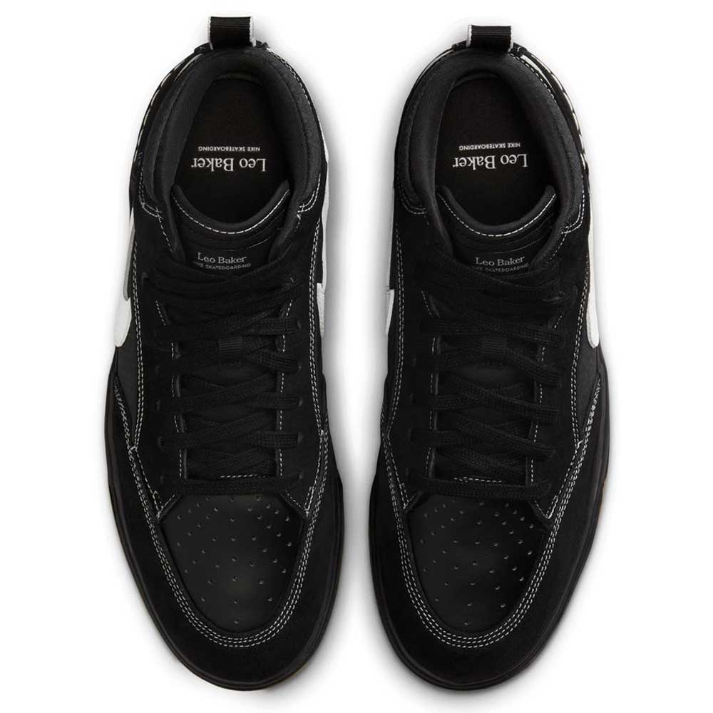 The DX4361005 Black Gum Leo Baker React Nike SB features black suede leather, white stitching, black laces, and perforated toe boxes. Viewed from above, insoles show "Leo Baker" in white text. Durable skateboarding shoes with white detailing.