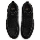 The DX4361005 Black Gum Leo Baker React Nike SB features black suede leather, white stitching, black laces, and perforated toe boxes. Viewed from above, insoles show "Leo Baker" in white text. Durable skateboarding shoes with white detailing.