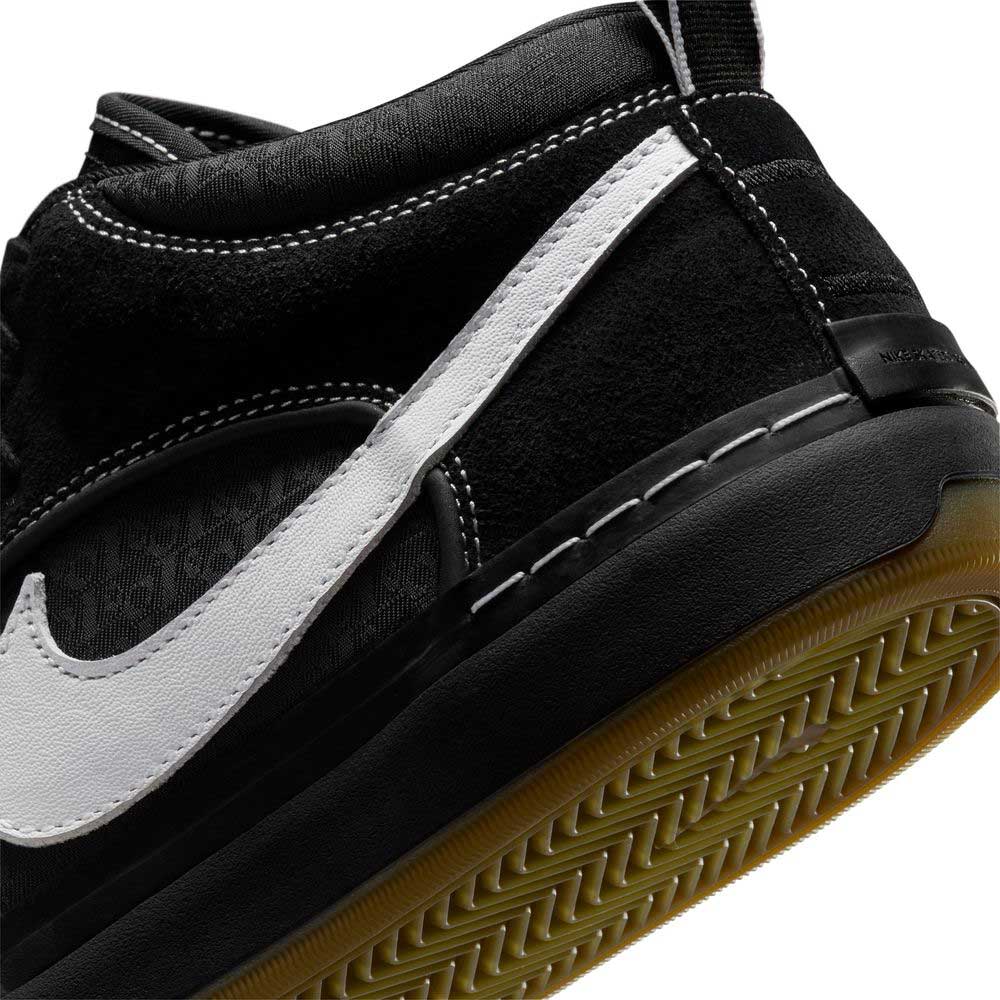 Close-up of the DX4361005 Black Gum Leo Baker React Nike SB skate shoe in black suede leather with a white Swoosh, black midsole, and gum rubber herringbone outsole, designed for durable skateboarding performance.