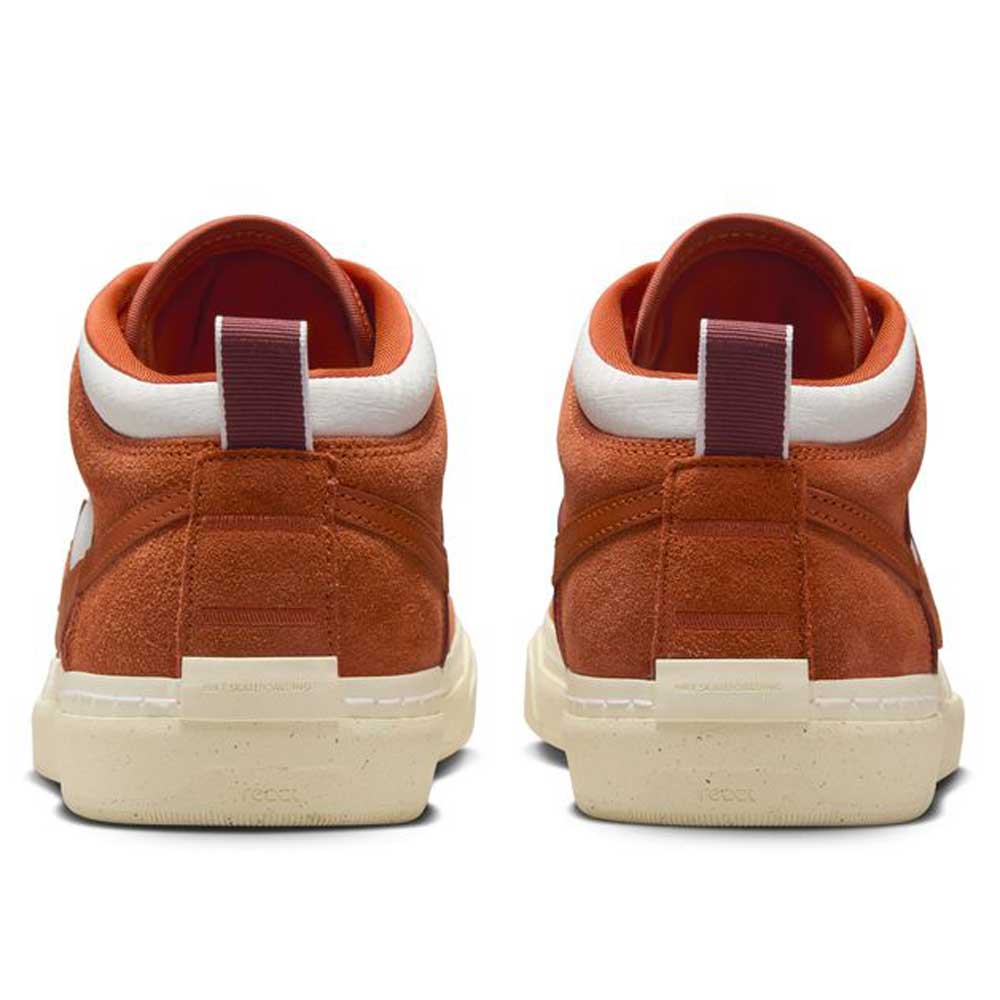 Back view of two DX4361202 Dark Rust White React Leo Nike SB suede & leather skateboarding shoes, featuring cream soles, white ankle trim, and dark red heel pull tabs, displayed side by side on a white background.