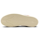 The image displays the bottom view of the Nike SB React Leo DX4361-202 Dark Rust White skateboarding shoe. Its light beige sole, made from suede and leather, has a herringbone zigzag tread for enhanced traction and grip.