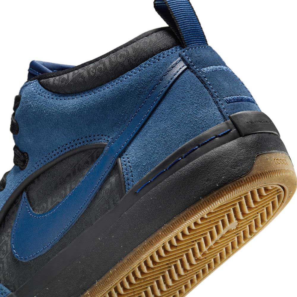 Close-up of the DX4361401 Navy Black Anthracite Leo Baker React Nike SB Suede Leather Skateboarding Shoe, highlighting its blue suede upper, black midsole, and gum outsole with herringbone traction.