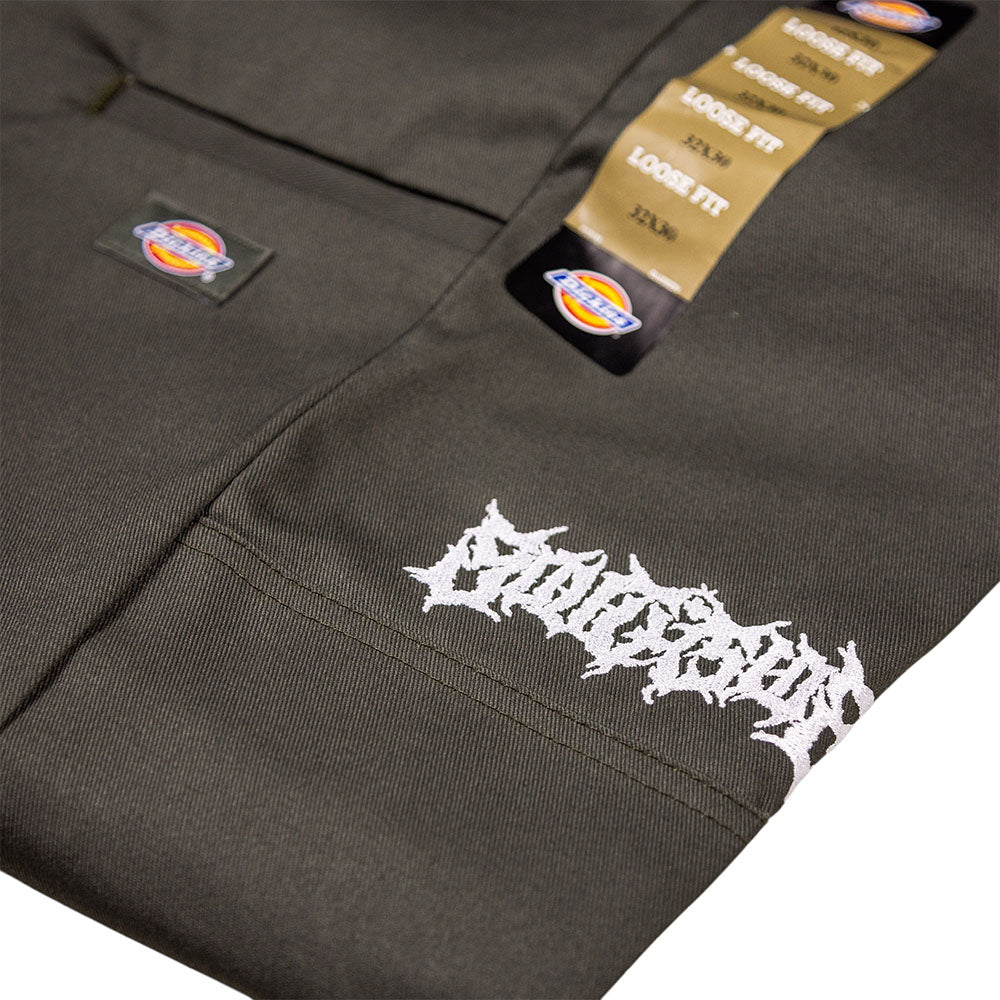 Close-up of olive green Southside Texas Icon Dickies Loose Fit Double Knee Pant 85283OG, featuring a relaxed fit and signature labels, with a white embroidered logo in a stylized, jagged font near the pocket.