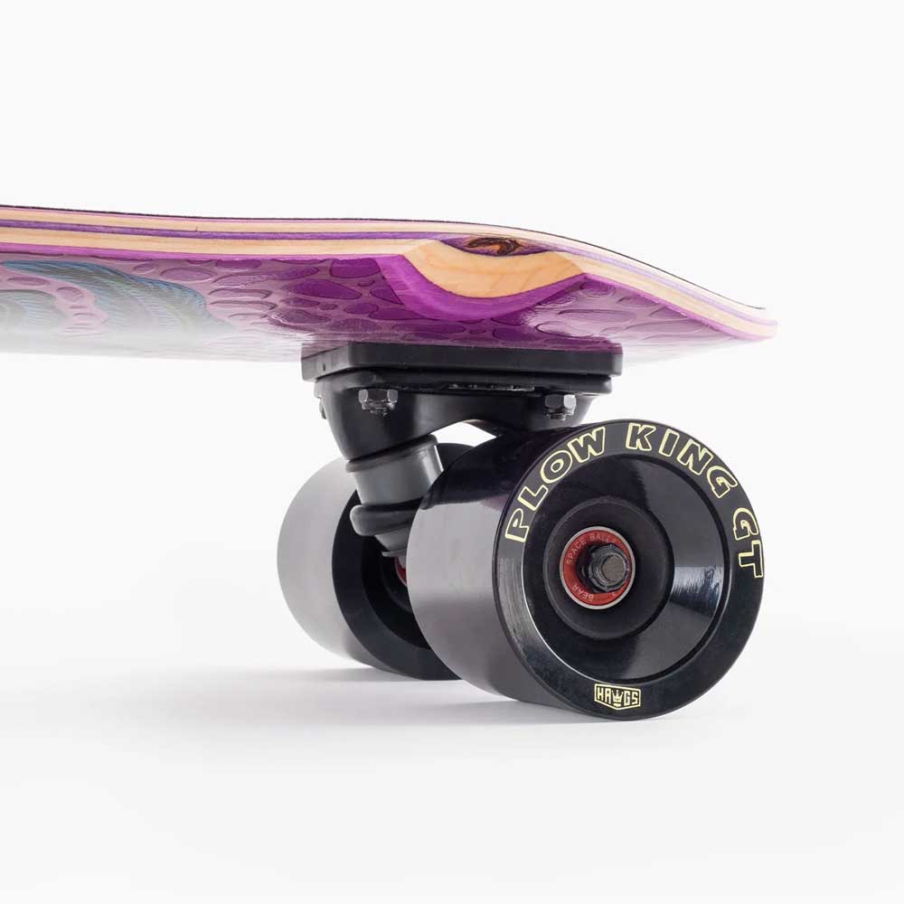 Close-up of the Dinghy Classic Fender Moray Eel Landyachtz Complete Skateboard’s rear truck and 74mm Plow King GT wheels, featuring a purple deck with layered wood edges, set against a white background.