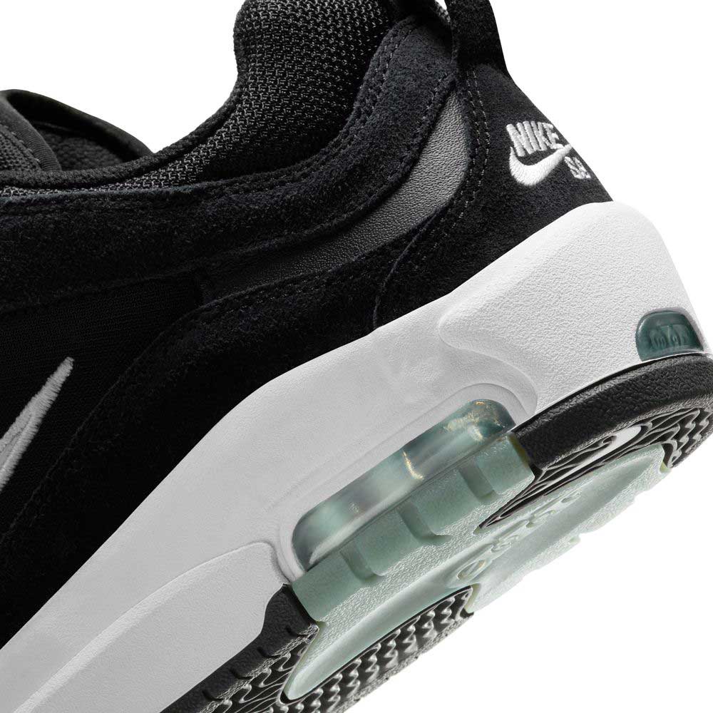 Close-up of the heel of the FB2393-004 White Black Air Max Ishod Wair Leather Suede Shoe, showcasing visible Max Air in the sole, a textured black upper, white midsole, and Nike SB logo on the heel tab.