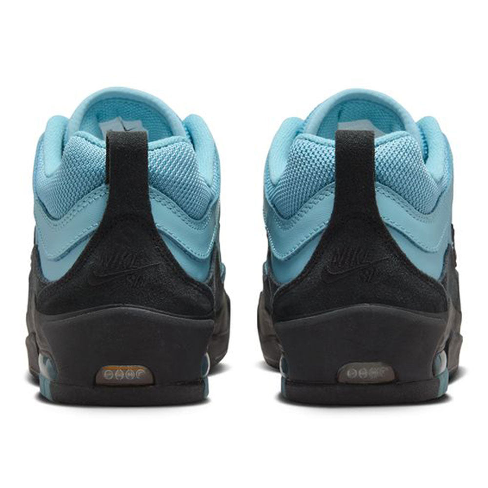 A pair of FB2393400 Denim Turq Black Denim Air MAX Ishod Nike SB suede leather skateboarding shoes seen from the back, with light blue uppers, black heel overlays and midsoles, heel pull tabs, inspired by Air Max Ishod's performance-ready design.