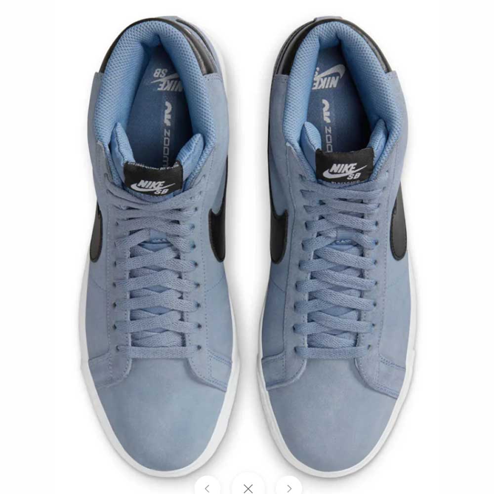 A top view of the FD0731-401 Ashen Slate Blazer Mid Nike SB suede shoes, featuring light blue uppers, black swooshes, black tongue labels, and light blue laces on a white background.
