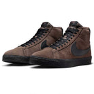 The FD0731-201 Baroque Brown Black Blazer Mid Nike SB Suede Skateboarding Shoes feature brown suede, black laces, a large black Swoosh, responsive cushioning, and black rubber soles, shown here against a white background.
