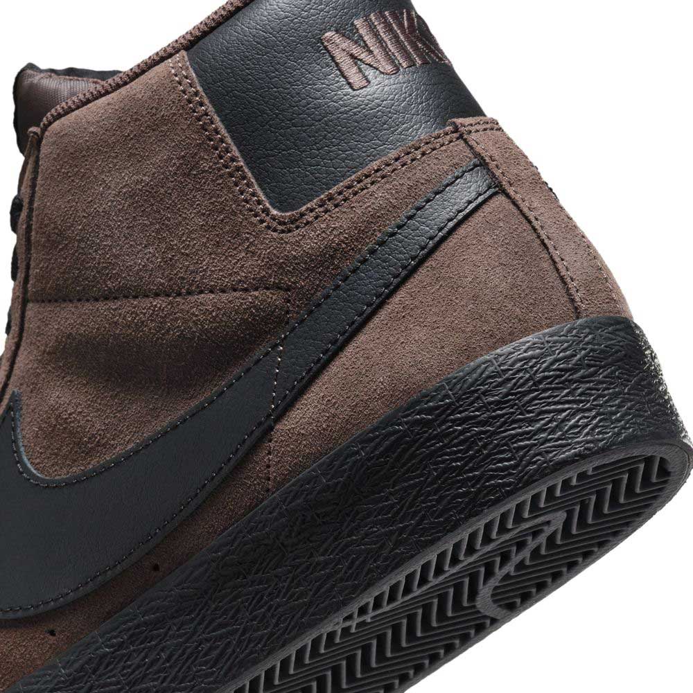 Close-up of the heel and sole of the FD0731201 Baroque Brown Black Blazer Mid Nike SB suede skateboarding shoes, featuring responsive cushioning, a black rubber sole, black leather accents, and an embossed NIKE logo on the heel.