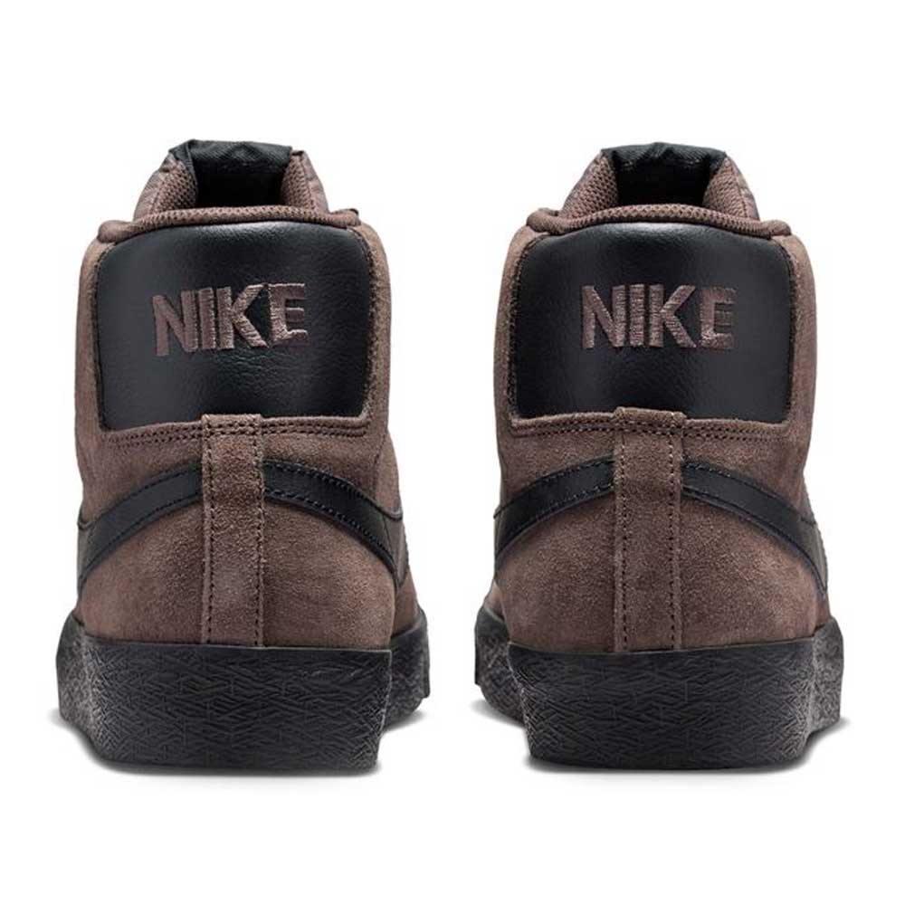 The FD0731-201 Baroque Brown/Black Blazer Mid Nike SB suede skateboarding shoes feature high-top design, black accents, responsive cushioning, and bold white NIKE lettering on the heel tabs for a classic skater look.