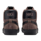 The FD0731-201 Baroque Brown/Black Blazer Mid Nike SB suede skateboarding shoes feature high-top design, black accents, responsive cushioning, and bold white NIKE lettering on the heel tabs for a classic skater look.