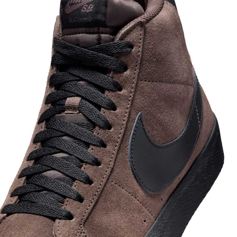 Close-up of the FD0731201 Baroque Brown Black Blazer Mid Nike SB Suede Skateboarding Shoe featuring brown suede upper, black laces, black swoosh, and textured sole for responsive cushioning on a high-top skate sneaker.