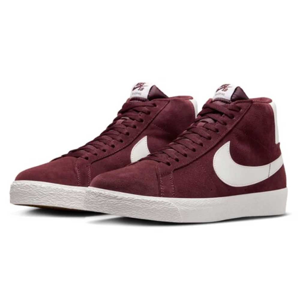 A pair of FD0731600 Burgundy Crush Summit White Blazer Mid Nike SB suede shoes with white swooshes and midsoles, featuring a classic high-top skateboarding design, shown on a plain white background.