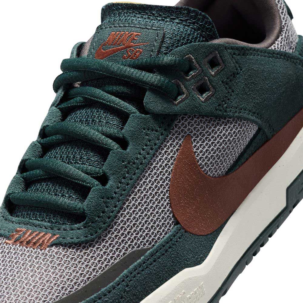 Close-up of the FN4210302 Seaweed Red Sepia Medium Ash YOUTH Day One GS Nike SB Shoes featuring dark green suede, brown mesh and swoosh, brown SB logo on the tongue, green laces, white midsole, and responsive Zoom Air cushioning.