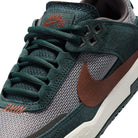 Close-up of the FN4210302 Seaweed Red Sepia Medium Ash YOUTH Day One GS Nike SB Shoes featuring dark green suede, brown mesh and swoosh, brown SB logo on the tongue, green laces, white midsole, and responsive Zoom Air cushioning.