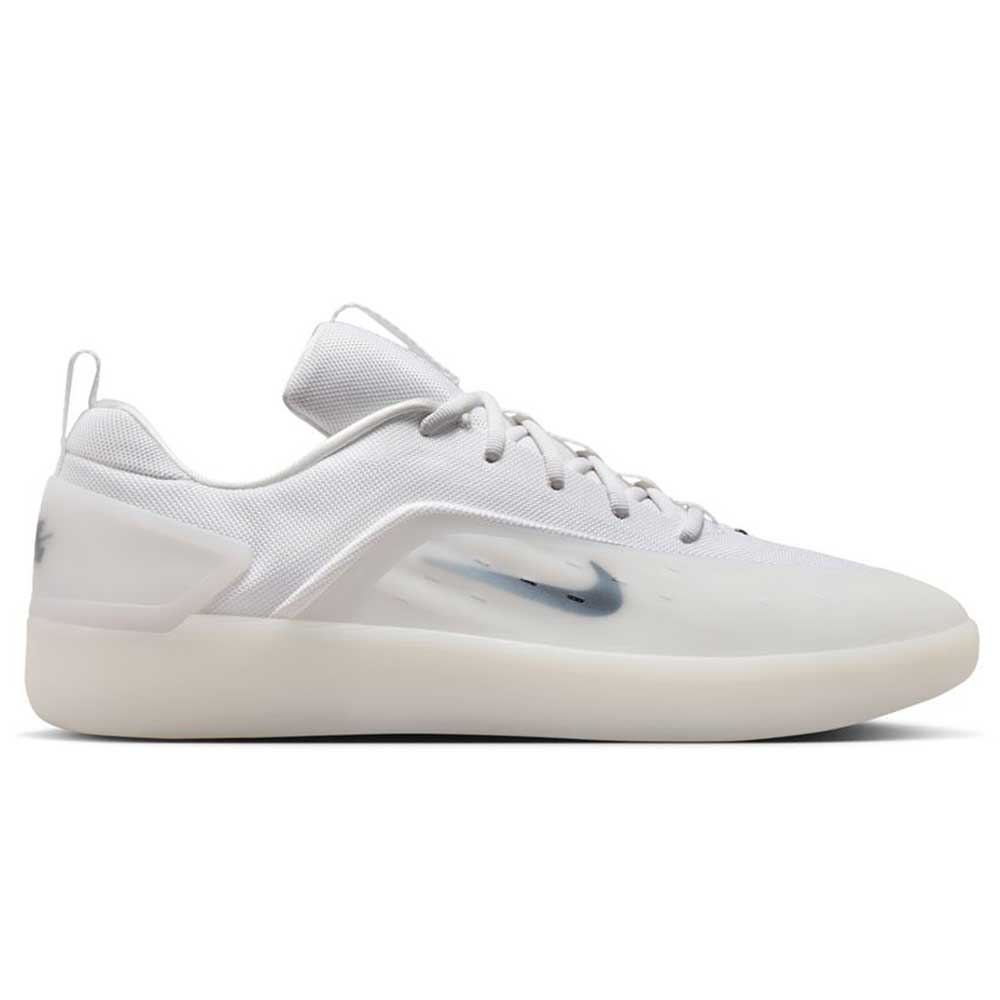 The FQ1273100 White Black Zoom Nyjah 4 Nike SB Skateboarding Shoes feature a white design with a translucent side panel, subtle dark grey Swoosh, white laces, thick white sole, and responsive Air Zoom cushioning for enhanced comfort.