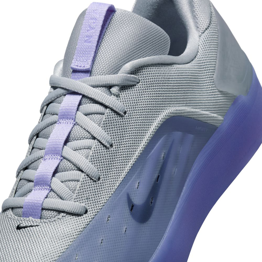 Close-up of the Nike SB Zoom Nyjah 4 FQ1273500 in Light Thistle Black, featuring a reinforced mesh upper, light purple lace accents, translucent purple Air Zoom midsole, and the Nike logo on the side panel.