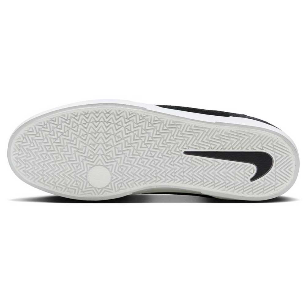 The image shows the sole of the FV6064001 Black White Malor Nike SB Suede Skateboarding Shoes featuring a herringbone tread pattern and a large black Nike Swoosh logo on the bottom.