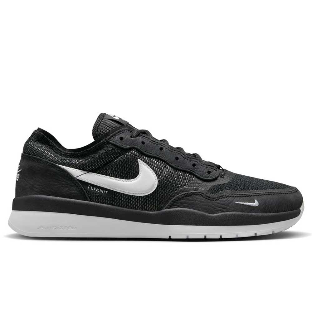 The FV8493-003 Black White PS8 Nike SB shoes feature a leather and knit upper, black laces, white sole, mesh panels, Flyknit text, subtle branding on the side and tongue, and a durable HART outsole for enhanced grip.