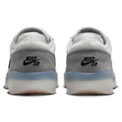 Back view of two FV8493004 Grey White PS8 Nike SB Leather Knit Shoes, showing the black Nike SB heel logo, translucent rubber outsoles, and responsive Air Zoom cushioning for comfort.