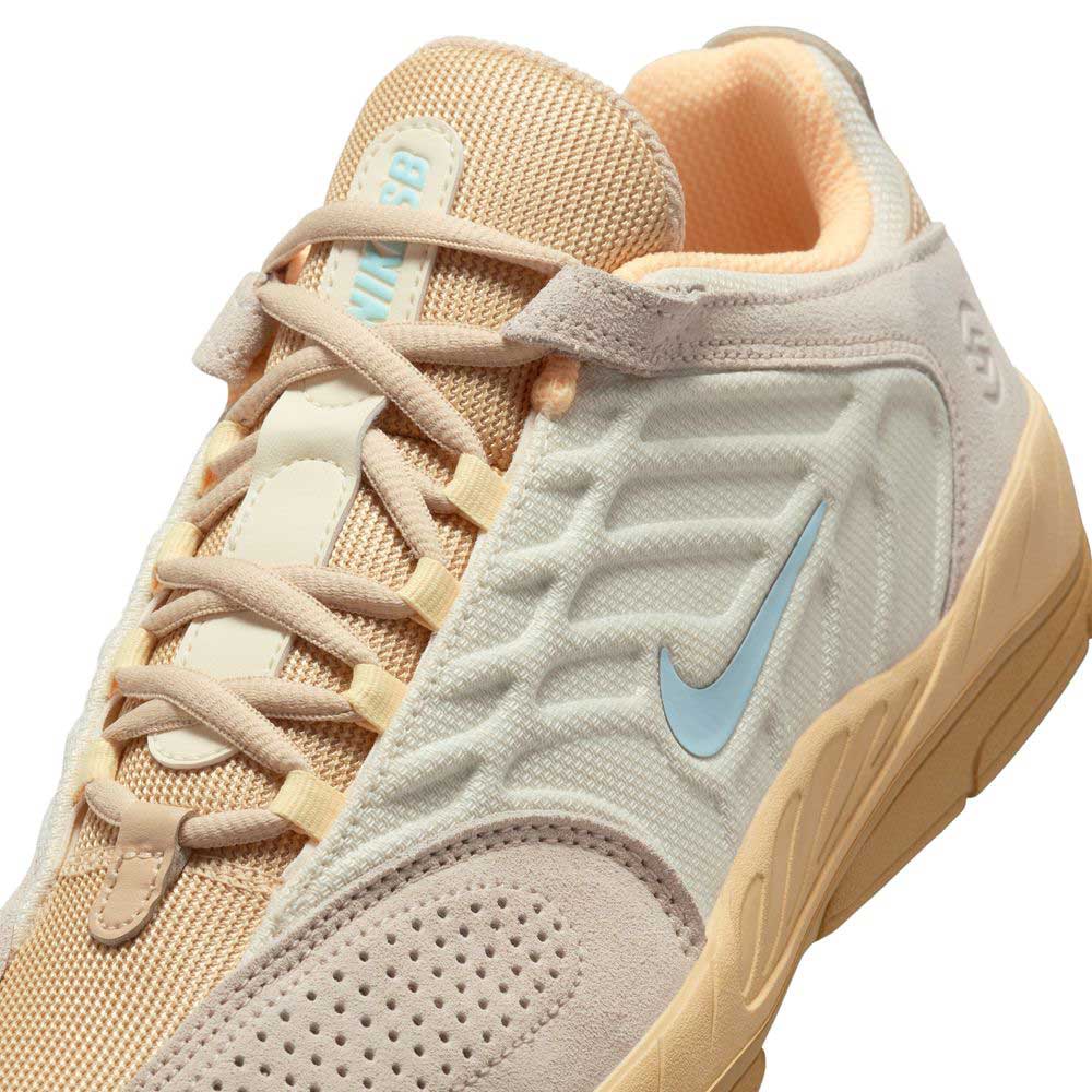 A close-up of the Nike SB Suede Shoes (FZ4878100) in Summit Coconut Milk, Jade Ice, Sesame, and Vertebrae, featuring mesh and suede textures, a blue swoosh, detailed stitching, and the Nike SB logo on the tongue.