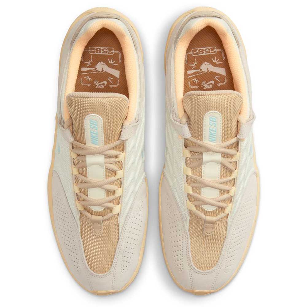 Top view of FZ4878100 Summit Coconut Milk Jade Ice Sesame Vertebrae Nike SB suede shoes, featuring light tan laces, mesh tongues with light blue branding, and insoles with stylized animal graphics.