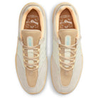 Top view of FZ4878100 Summit Coconut Milk Jade Ice Sesame Vertebrae Nike SB suede shoes, featuring light tan laces, mesh tongues with light blue branding, and insoles with stylized animal graphics.