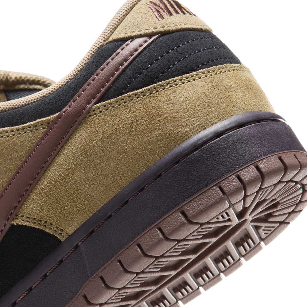 Close-up of the heel and outsole of the Filbert Light Chocolate Black Burgundy Ash Dunk Low Pro HQ1625201 Nike SB Skateboarding Shoe, featuring tan suede, black accents, a brown stripe, and a detailed tread pattern on the sole.