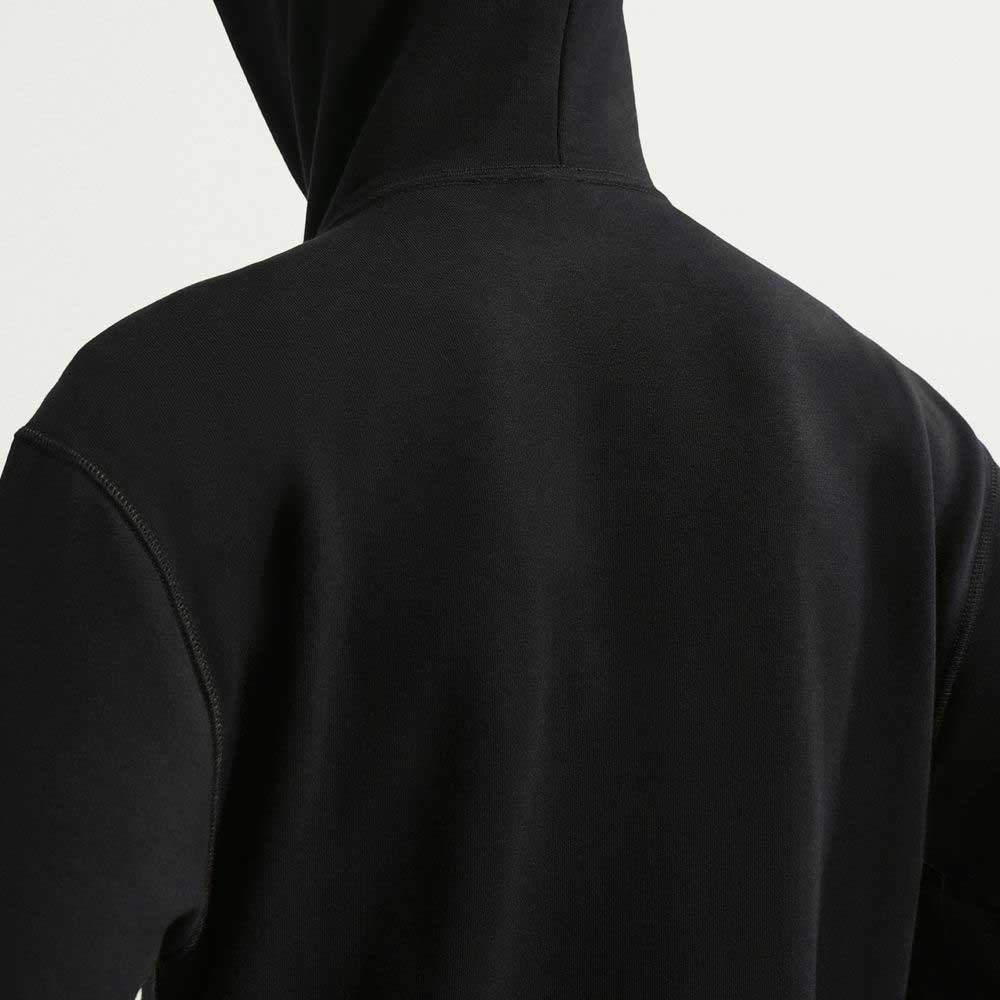 A person is shown from the back wearing a Nike SB Fleece Pullover Black White IF0655010 hoodie with a relaxed fit. Only the hood, upper back, and shoulders are visible against a plain light background.