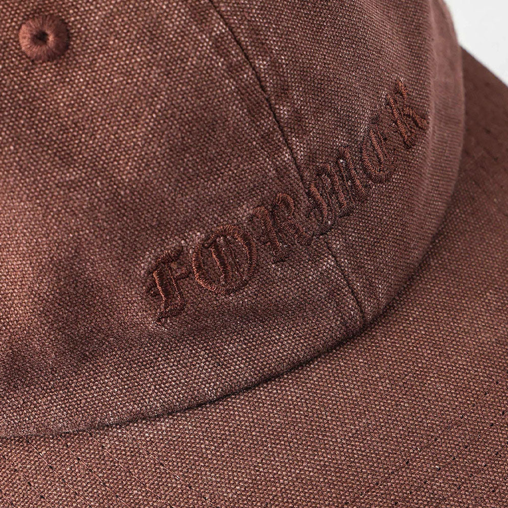 A close-up of the Alleviate Cap Former Hat Bark, a brown fabric baseball cap featuring the word FOREVER embroidered in dark brown gothic-style letters on the front, reminiscent of a bold vintage T-shirt screen print.