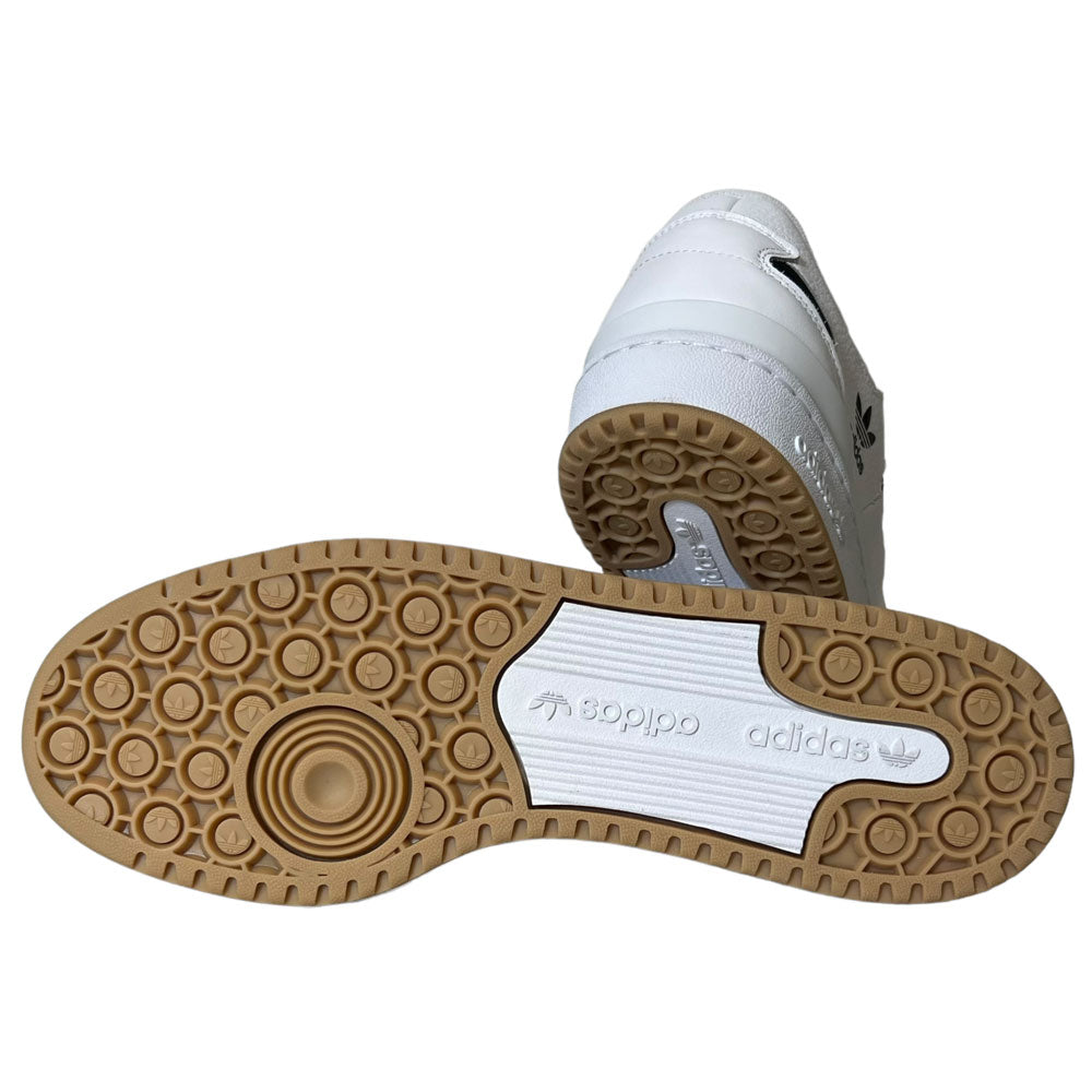 A pair of Forum 84 Low Adidas Skateboarding Cloud White/Core Black leather shoes—one upright showing the back, the other on its side displaying a brown patterned sole with adidas logo and name—perfect for skateboarding fans.