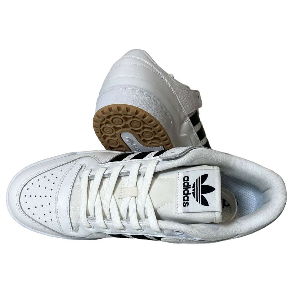 A pair of Forum 84 Low Adidas Skateboarding Cloud White/Core Black leather shoes—one upright showing the Adidas logo on the tongue, the other on its side to display the gum-colored sole—perfect for skateboarding fans.