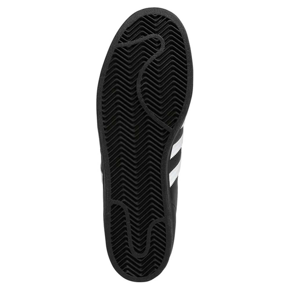 The image shows the black rubber sole of the GW6931 Black White Superstar ADV Adidas Skateboarding Leather Shoes, featuring a zigzag herringbone tread and a signature white stripe partially visible on the side.