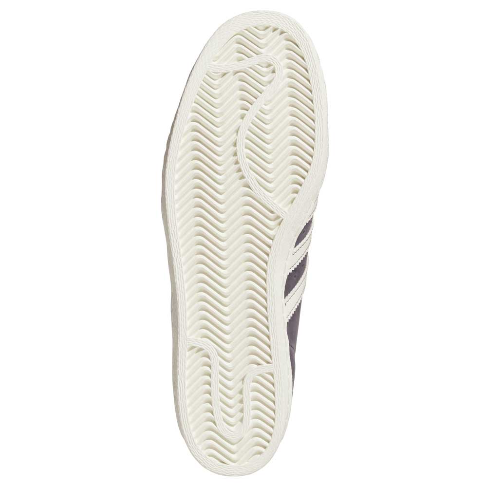 The image shows the sole of the Grey White Superstar 80 ADV HQ9289 Adidas Skateboarding Leather Shoes, with a white rubber outsole in a zigzag herringbone pattern and a textured edge, hinting at its classic leather design.