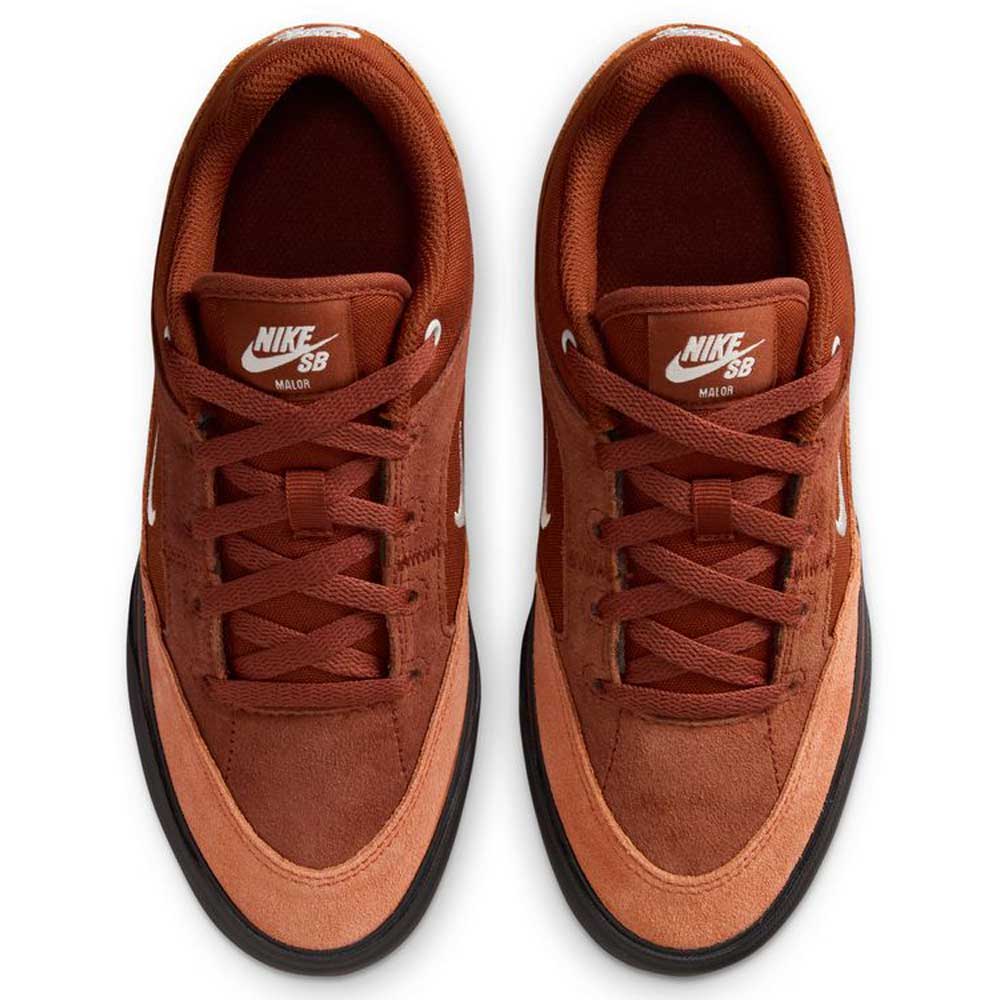 Top view of a pair of HF1205200 Cinnamon Light Bone YOUTH Malor GS Nike SB shoes with black soles, white tongue logos and swooshes, brown laces, suede uppers, and a durable design for young skaters.