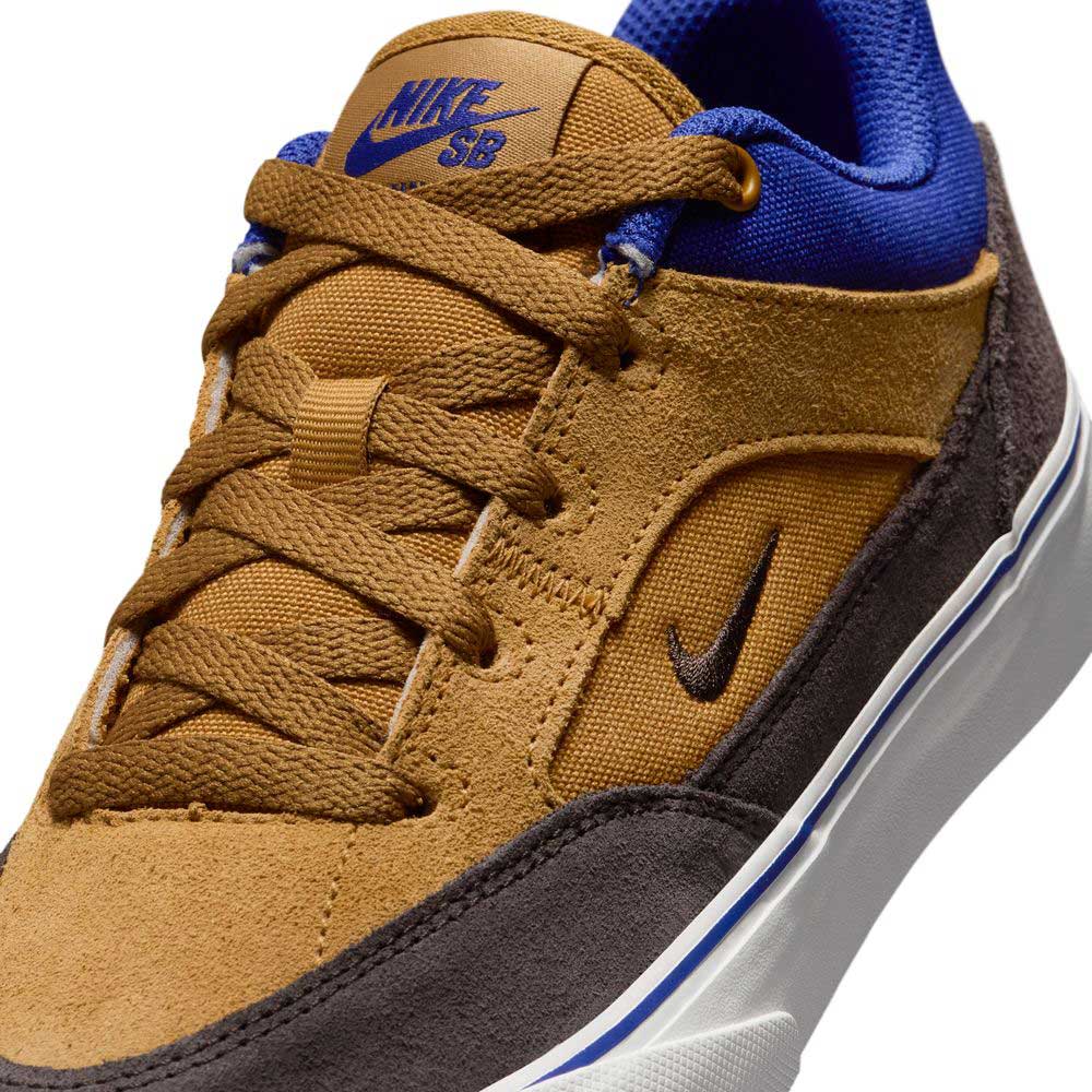 Close-up of the HF1205700 Wheat Velvet Brown Deep Night YOUTH Malor GS Nike SB Shoes, featuring durable brown suede, blue accents, brown laces, a black Nike swoosh on the side, and a white sole with a blue stripe.