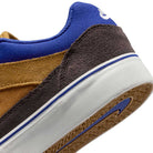 Close-up of the HF1205700 Wheat Velvet Brown Deep Night YOUTH Malor GS Nike SB: brown suede heel, blue collar, white midsole with blue stripe, tan and blue outsole—ideal durability for skate shoes.