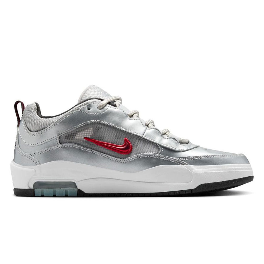 The HF3062001-Silver-Bullet-Air-Max-Ishod-Wair-Leather-Suede-Shoes feature a metallic silver and white upper, red Nike swoosh, white laces, Max Air cushioning in the midsole, black outsole, and heel pull tab for comfort and style.