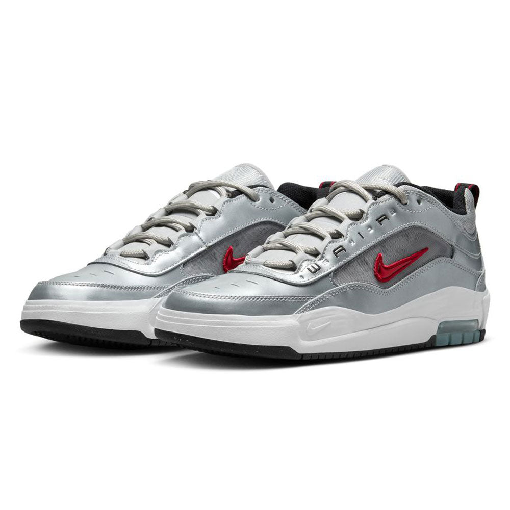 The HF3062001-Silver-Bullet-Air-Max-Ishod-Wair-Leather-Suede-Shoes feature a silver low-top design, red Nike swooshes, white midsoles, black outsoles with teal accents, Max Air tech, and "AIR" lettering on the lace area.