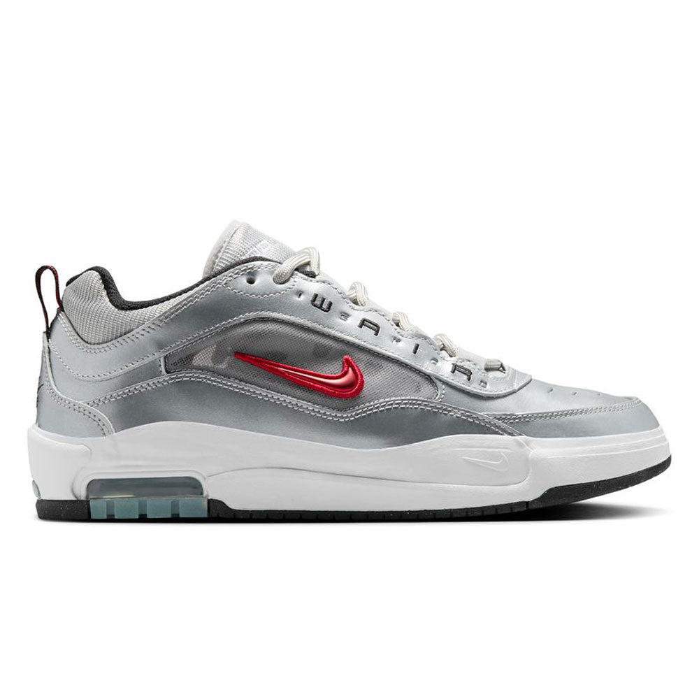 The HF3062001 Silver Bullet Air Max Ishod Wair Leather Suede Shoes feature a silver upper, white sole, red metallic Swoosh, black accents, Max Air heel tech, grey laces, and blend modern sporty style with skate shoe comfort.